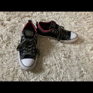 Black and red low top Converse with green laces
